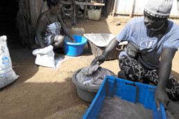 A man stacks fish in a plastic container. Community Centre Conservation (C3) Madagascar: ECOFISH