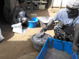 A man stacks fish in a plastic container. Community Centre Conservation (C3) Madagascar: ECOFISH